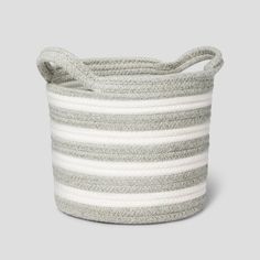 a grey and white striped basket with handles