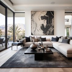 a living room with a large painting on the wall and couches in front of it