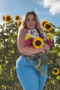 A woman stands amid tall sunflowers, holding a bouquet of sunflowers, roses, and daisies. She wears jeans under a bright sky, conveying a serene, joyful mood. Facing Challenges, Flower Shirt, Coach Dinky Crossbody, Sunflower, Fashion Blogger, Plus Size