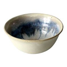 a white and blue bowl on a white background with black swirls in the center