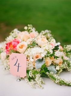 a bouquet of flowers on top of a table with a sign that says i love you