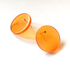 Incredibly mod and so today! These are transparent orange stud earrings in a retro mod disc shape. Just about 1" or 25mm in diameter and wafer thin, these button earrings are the perfect mix of classic and mod retro. The model is wearing a different color / floral patterned earring but very close in size and shape. Most all earrings are made with vintage lucite parts that were made in Rhode Island in the 1960's - early 80's by Best Plastics. We hand-set them with surgical steel earring posts and Surgical Steel Earrings, Orange Earrings, Button Earrings, Earring Posts, Vintage Lucite, Rhode Island, Post Earrings, Different Colors, Etsy Earrings