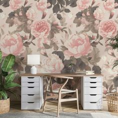 a room with a desk, chair and wallpaper that has pink flowers on it