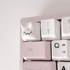 a computer keyboard with a white cat on it's side and the words tab