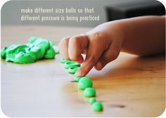 a child's hand reaching for green balls on the floor with an inspirational quote above it