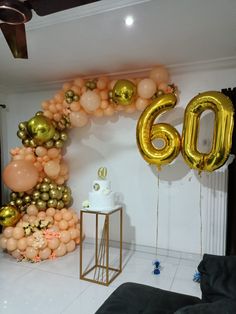 balloons are arranged in the shape of an arch and number 60, along with other decorations