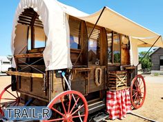 an old fashioned wagon is parked in the dirt