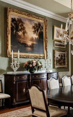 a dining room table with chairs and a chandelier hanging from the wall above it