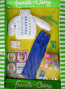 the package is packed with clothes and accessories for doll making, including a cardigan