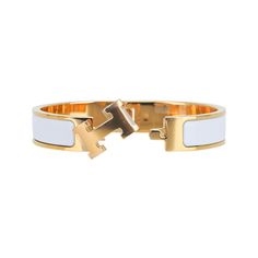 Hermes Clic H Bracelet featured in white Enamel.Set in Gold plated hardware.Chic, modern and unmistakably Hermes!A hinged band allows the H to swivel and open the bracelet.Comes with pouch and signature Hermes box.NEW or NEVER WORN.final saleSIZE: PM or SmallBRACELET MEASURES: DIAMETER 2.25"HEIGHT 0.47" CONDITION:NEW or NEVER WORN Hermes Clic H Bracelet, Pandora Bracelet Charms Ideas, H Bracelet, Hermes Bracelet, Hermes Jewelry, Hermes Accessories, Hermes Box, Bracelet Charms, Pandora Bracelet Charms