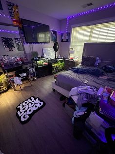 a bed room with a neatly made bed and purple lights