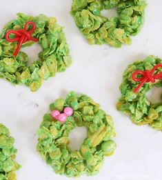 four wreaths made out of green cereal krispy kreme treats on a table