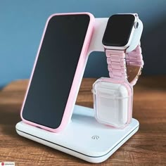 an apple watch and cell phone stand on a table