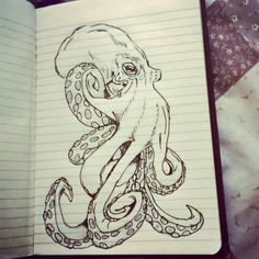 an open notebook with a drawing of an octopus