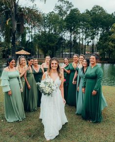 a bride and her bridal party in front of the lake