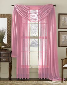 pink sheer curtains hanging in front of a window