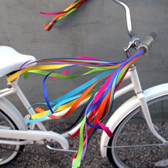 a white bike with colorful ribbons attached to it