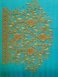 an embroidered piece with gold thread and beads on blue fabric, which has been stitched together