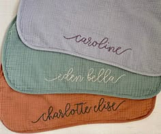 three personalized pillows with embroidered names on them