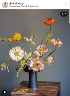 an arrangement of flowers in a black vase