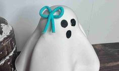 a close up of a fake ghost with a bow on it's head