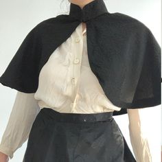 This wonderful textile is an antique French capelet, dating to the late 1800s. The black material is a beautiful textured silk blend fabric. This textile would have been worn about the shoulders as a stylish accent. It fastens at the neck with 2 metal hook and eye clasps. The collar is lined with a heave linen to keep it stiff, you can see it becuase the black fabric has come loose at the back of the neck. The rest of the cape is not lined, but the simple seams are reinforced with a kind of nett Black Capelet For Evening Wear, Black Capelet For Costume, Fitted Black Capelet, Black Fitted Capelet, Elegant Black Capelet For Costume, Formal Black Capelet, Elegant Black Formal Capelet, Capelet Outfit, Vintage Capelet