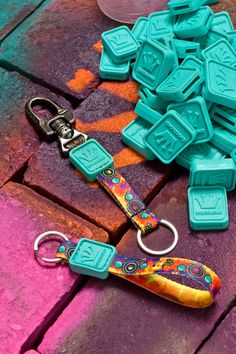 a bunch of ice cubes sitting on top of a wooden table next to a keychain