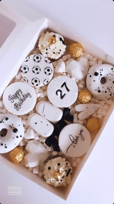 a box filled with lots of different types of buttons and confetti in it