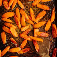 sweet potatoes on a baking sheet with herbs