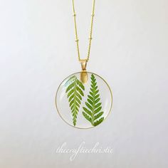 This magical necklace is crafted by systematically placing a delicate Fern in resin pendants. Choose your favorite necklace to go along with a beautiful gold chain. The Pendant and Chain are Lead free and Nickel Free! It is important to preserve the jewelry in the box provided safely after use. Enjoy this necklace with a chain length of your choice. You can see more of my Handmade Items here: https://www.etsy.com/shop/Thecraftiechristie Nature-inspired Green Jewelry With Birth Flower, Bohemian Resin Round Pendant Necklace, Bohemian Gold Resin Necklace, Nature-inspired Round Necklaces For Jewelry Making, Bohemian Pendant Necklaces With Pressed Flowers, Unique Necklace With Natural Inclusions In Round Pendant, Bohemian Leaf Necklace For Gift, Botanical Leaf Style Jewelry As Gift, Nature-inspired Gold Resin Jewelry