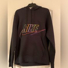 Nike Hoodie Black With Multicolored Logo/Lettering Size Medium Kangaroo Pocket Tag Removed But Never Worn & In New Condition Nike Hoodie With Logo Print For Fall, Nike Long Sleeve Hoodie With Logo Print, Nike Sporty Hoodie With Graphic Print, Nike Graphic Print Sweatshirt For Winter, Nike Winter Sweatshirt With Graphic Print, Nike Black Hoodie For Fall, Nike Black Sweatshirt With Drawstring Hood, Nike Urban Black Hoodie, Winter Nike Sweatshirt With Graphic Print