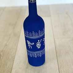 a blue bottle sitting on top of a wooden floor