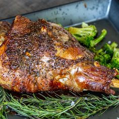 a piece of meat and some broccoli on a pan