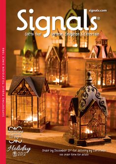 a magazine cover with candles and small houses