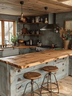 a kitchen with two stools next to an island in the middle of the room