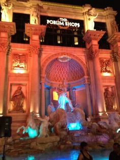 the fountain in front of the forum theatre at night