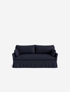 a blue couch sitting on top of a white wall