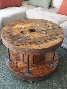 a table made out of wooden pallets with metal legs and wheels on the bottom