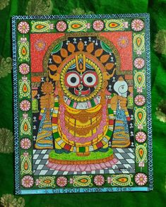 an intricately painted painting on green fabric