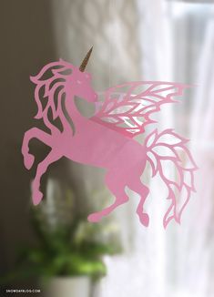 a pink paper cut out of a unicorn