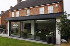 a modern extension to a house with sliding glass doors