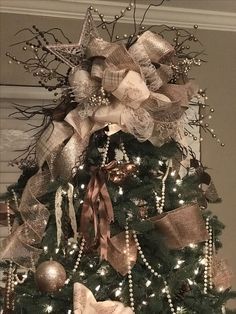 a christmas tree decorated with gold and silver ribbons