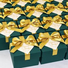 many green boxes with gold bows on them