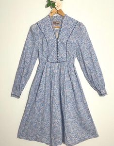 Vintage 1970's Origin dress, made with Liberty of London fabric. Beautiful floral print dress, 100% cotton and in excellent condition. Measurements to follow: Pit to pit 18ins Waist laid flat: 15ins Shoulder to hem: 44ins Always refer to measurements before purchasing. #LibertyDress #Prairie #LibertyPrint #BlueFloralDress #BlueDress 1970s Cotton Vintage Dress For Daywear, Light Blue Floral Print Cotton Dress, Light Blue Floral Cotton Dress, 1970s Style Blue Floral Print Dresses, Blue Fitted Cotton Floral Dress, Cotton Vintage Dress With Vintage Print For Daywear, Fitted Blue Cotton Floral Dress, Cotton Vintage Print Dress For Daywear, Blue Ditsy Floral Print Dress For Daywear