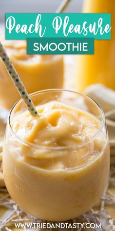 peach pleasure smoothie in a glass with a straw on the top and two oranges behind it