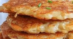 three pancakes stacked on top of each other with green onions and seasoning around the edges