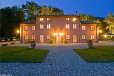 a large house lit up at night in the evening