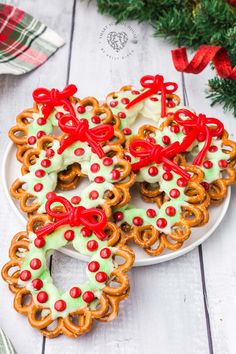 christmas pretzels on a white plate with green and red decorations