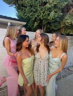 the girls are all laughing together in their dresses