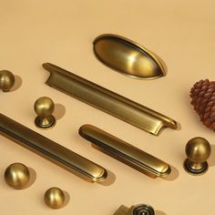 various brass door handles and knobs with pine cone on the top one side, next to each other